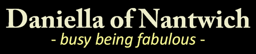 Shop logo, gold text black background reads Daniella Of Nantwich, busy being fabulous!